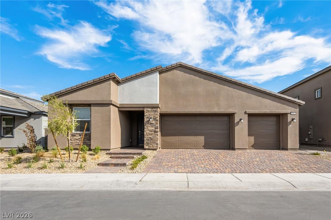 Image 1: A desert-friendly landscape surrounds a modern hom