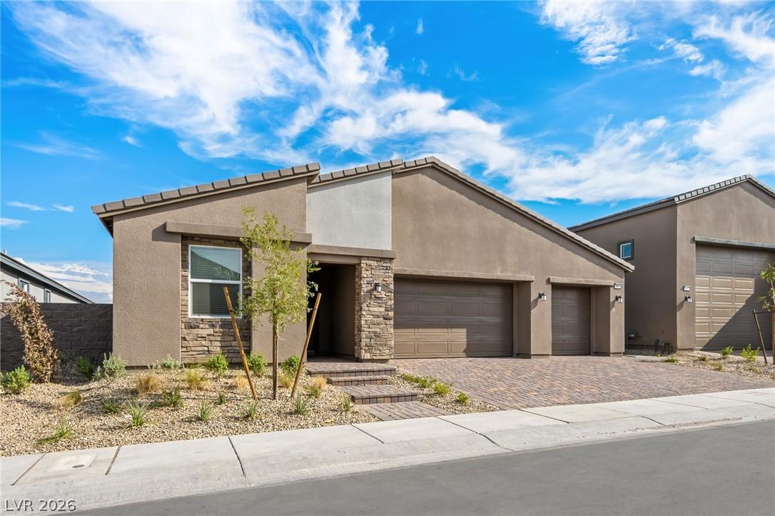 Image 2: A well-maintained stucco exterior and paver drivew