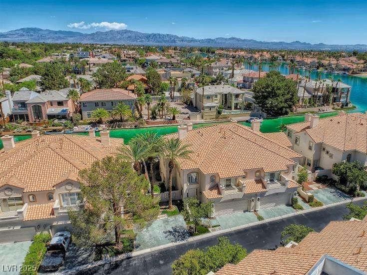 Image 2: Aerial view of residential area featuring a water