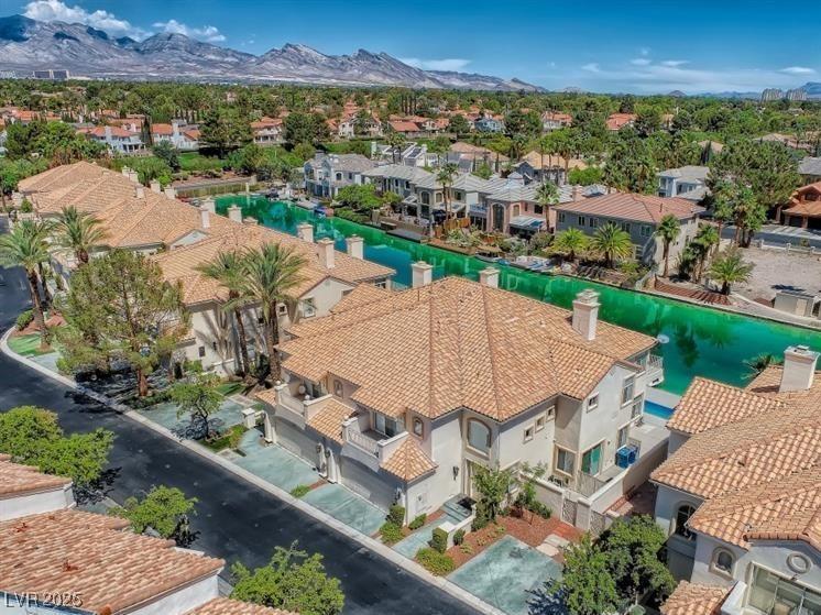 Image 3: Aerial perspective of suburban area with a water a