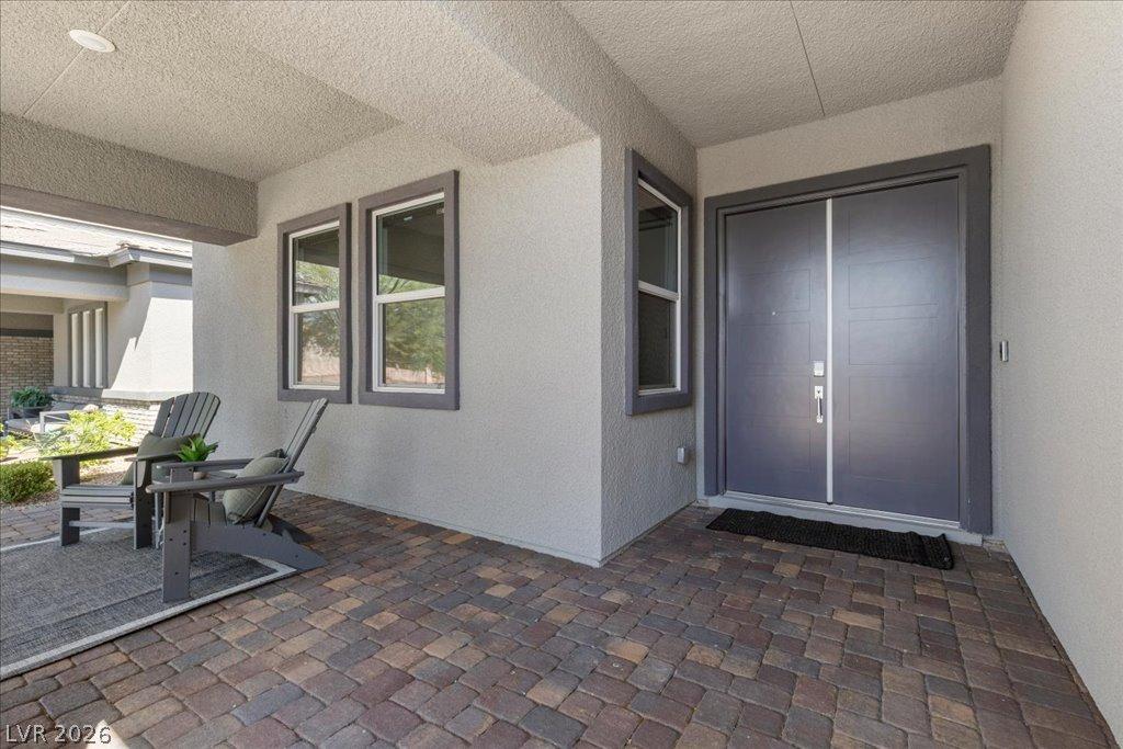 Image 3: A welcoming front entrance with double doors, a co