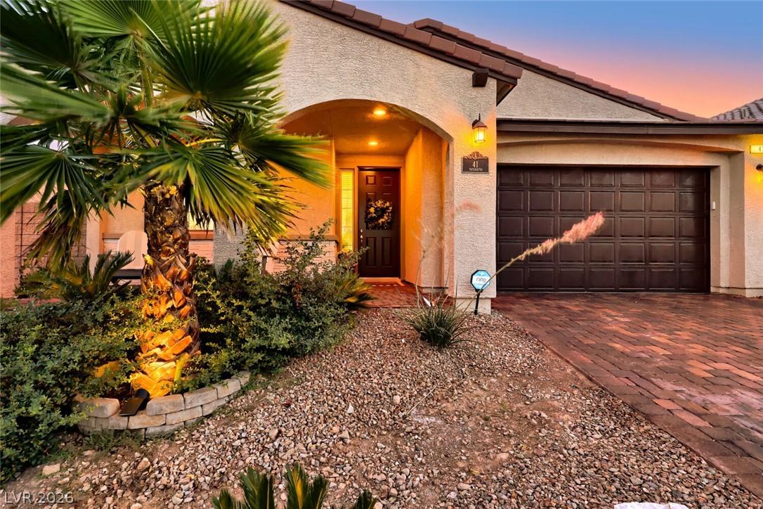 Image 3: A welcoming entry, with tasteful landscaping and a