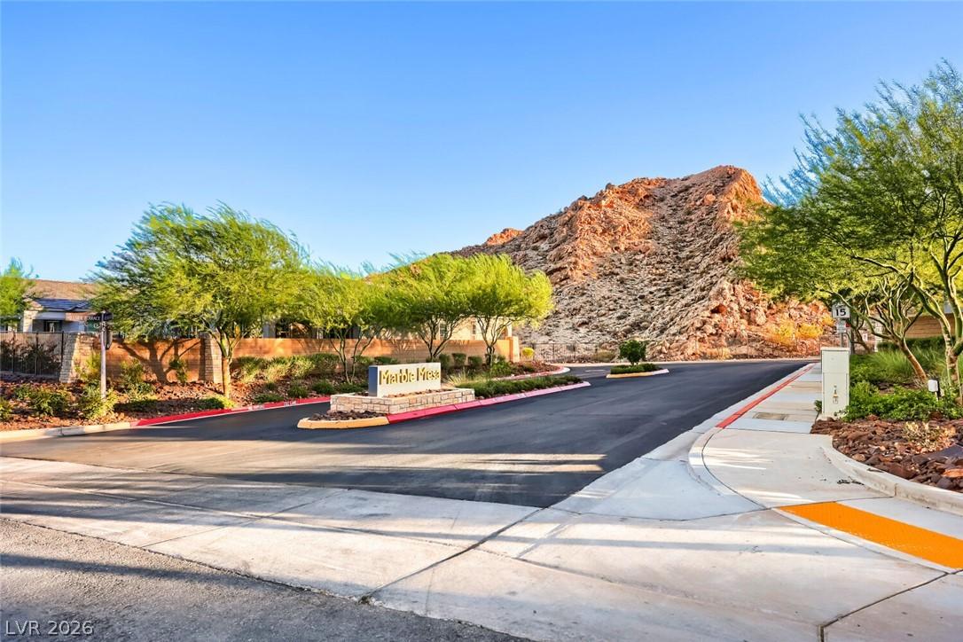 Image 4: A desert community entry with a stone sign, well-m