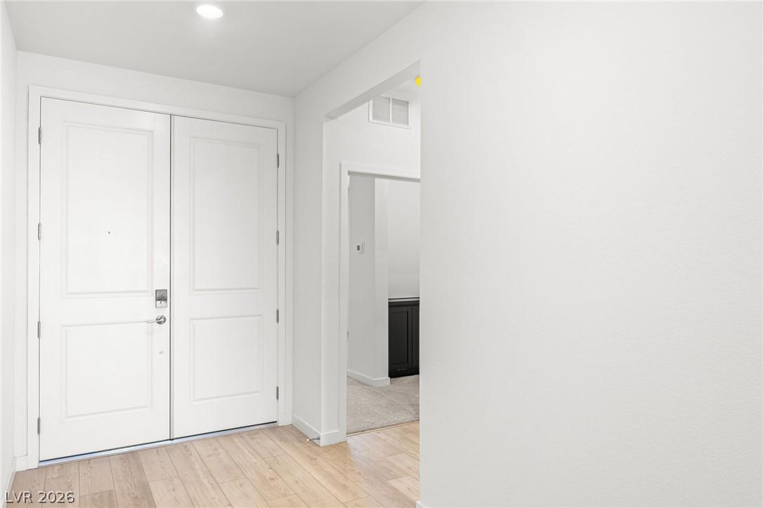 Image 3: A welcoming entry featuring wide plank flooring an