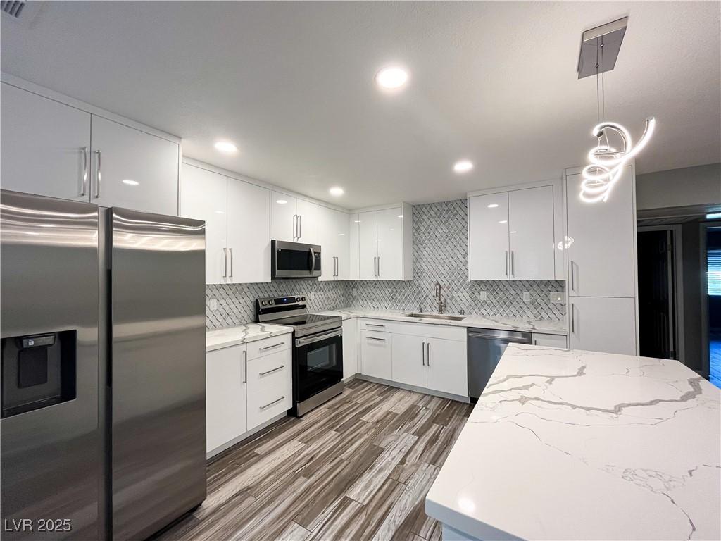 Image 2: Kitchen featuring stainless steel appliances, hang