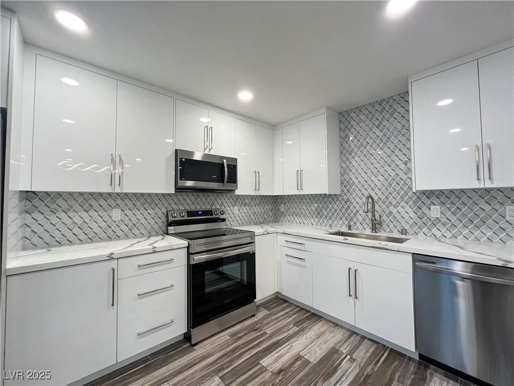Image 3: Kitchen with modern cabinets, appliances with stai