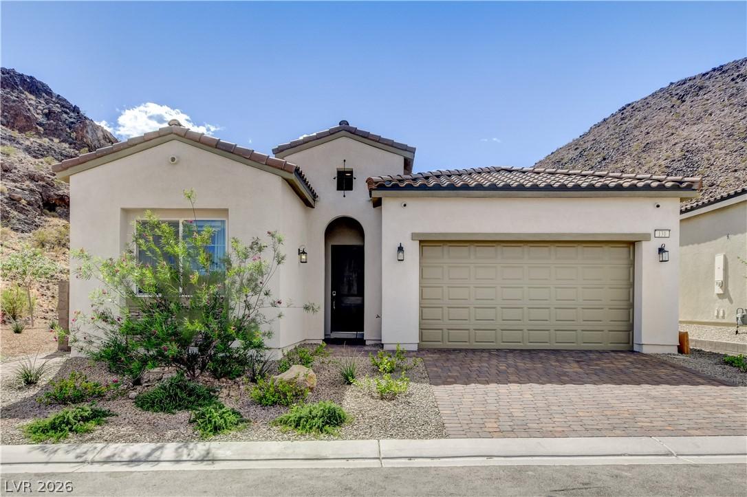 Image 2: This desert-adapted home presents a tiled roof, st