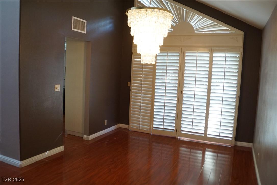 Image 4: Unfurnished room with a chandelier, dark wood-styl