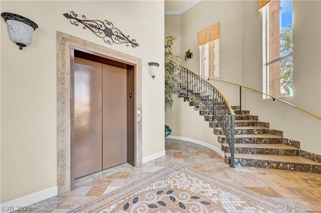 Image 2: Elegant elevator access and a grand staircase defi