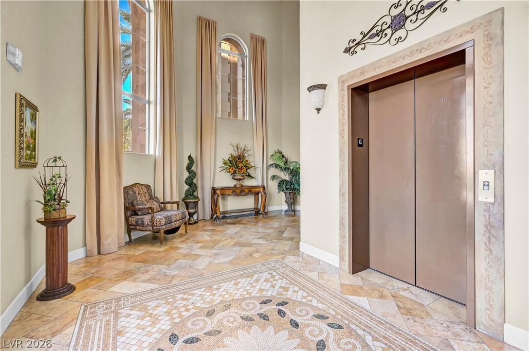 Image 3: Elegant entrance foyer with detailed tile flooring