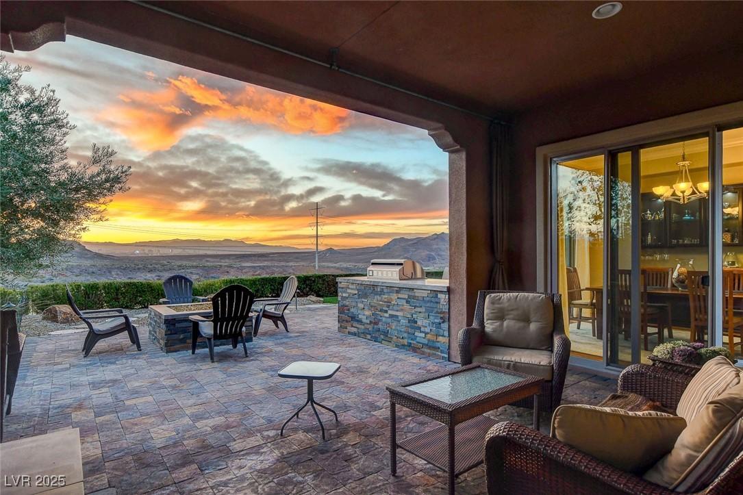 Image 3: View of patio with a fire pit and area for grillin