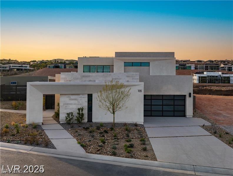 Image 2: Contemporary house with stucco siding, driveway, a