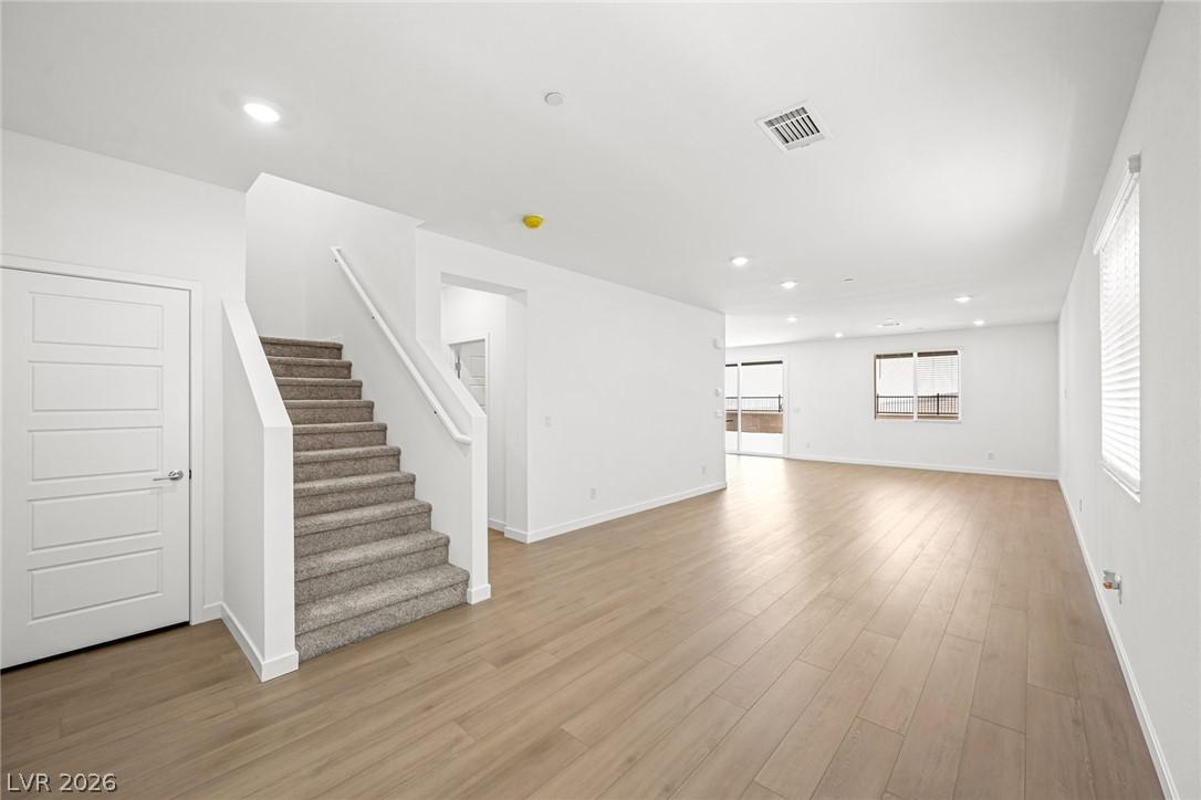 Image 3: A well-lit, open-concept living space awaits, feat