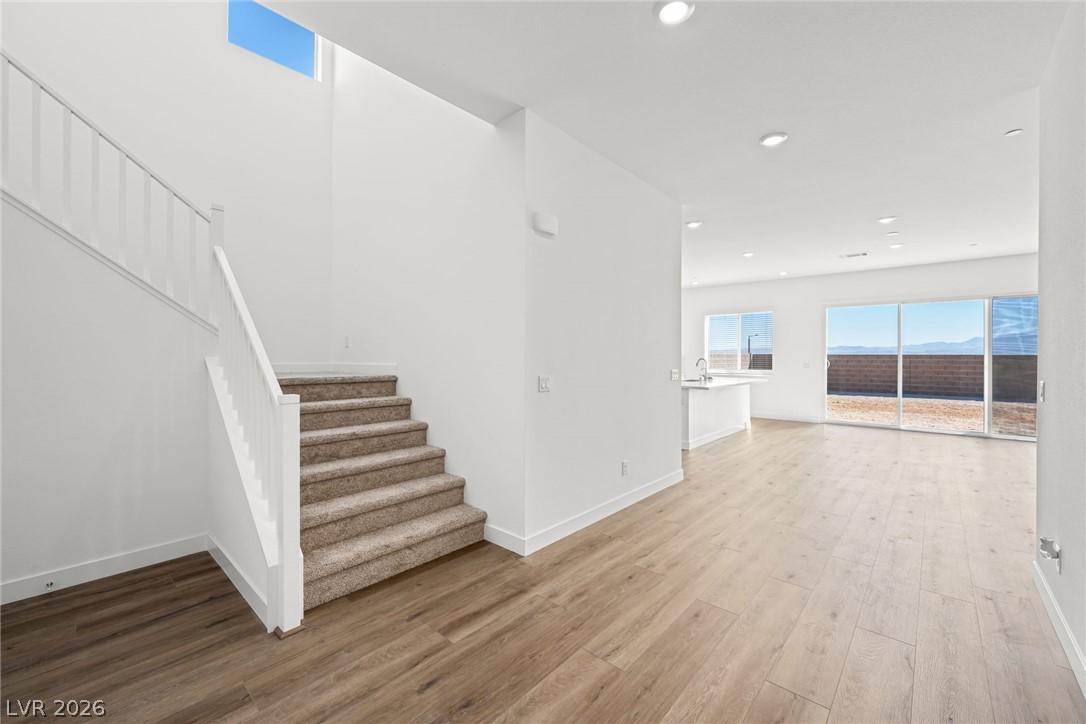 Image 3: A well-lit, open-concept interior features wood-lo