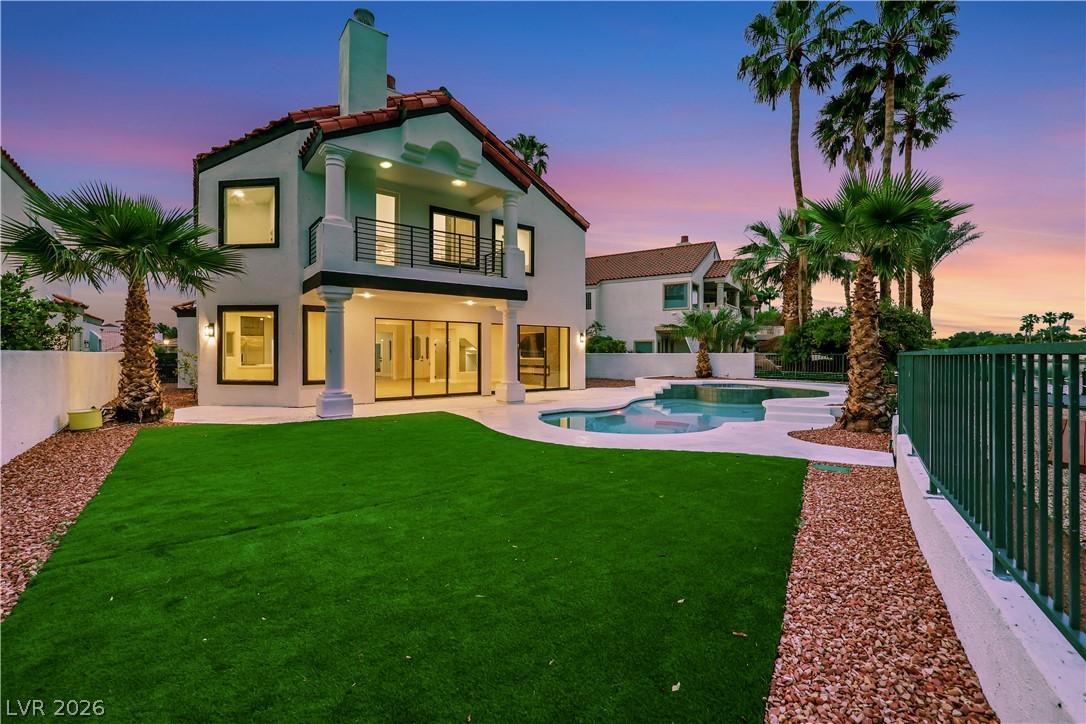 Image 1: Lush green lawn and sparkling pool create an invit