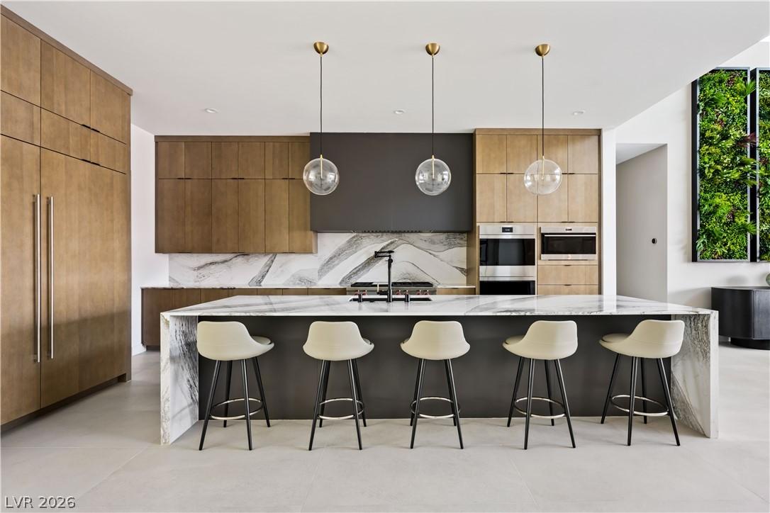 Image 3: A contemporary kitchen features an elegant marble