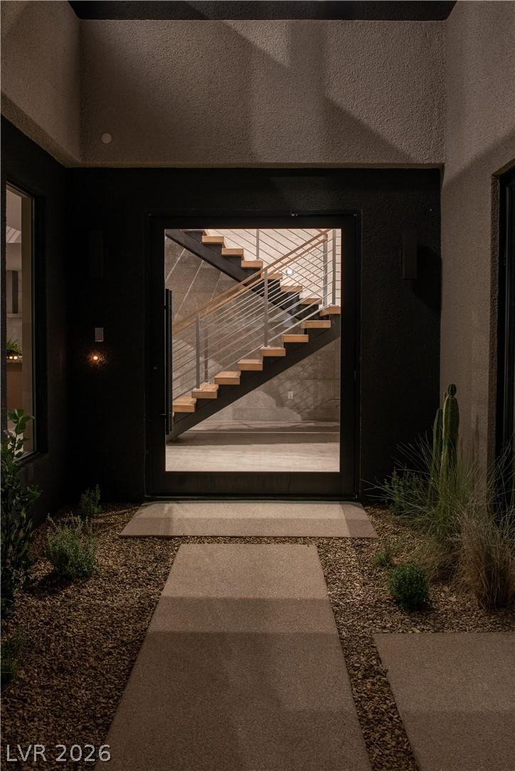 Image 4: A modern glass entry door reveals a striking float