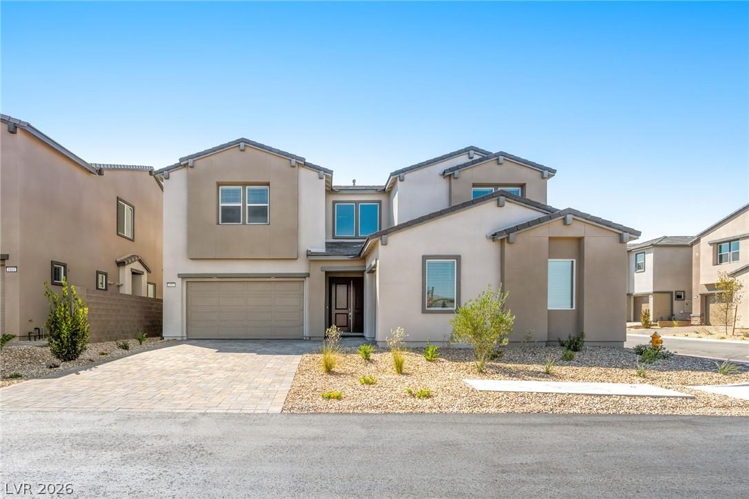 Image 1: Modern desert-style architecture with a spacious p