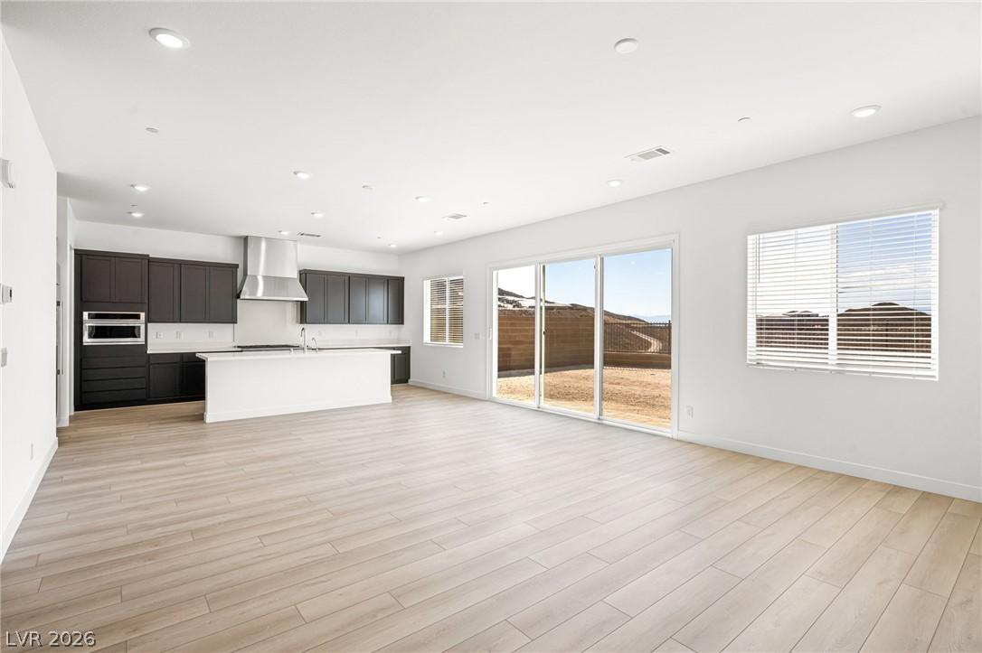 Image 3: An open-concept living space integrates a modern k