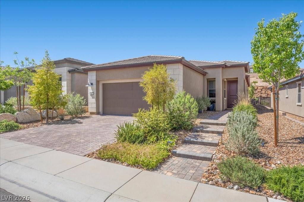 Image 1: Exterior with paver walkway and driveway.  Stonewo