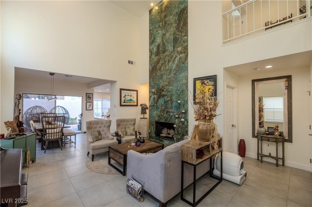 Image 1: Living room with light tile patterned floors, a ti