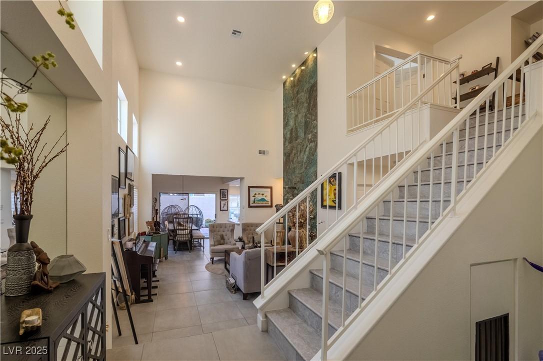 Image 4: Stairs with recessed lighting, a high ceiling, and