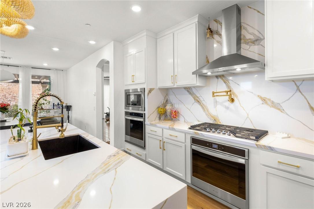 Image 1: This sleek kitchen features quartz countertops, a