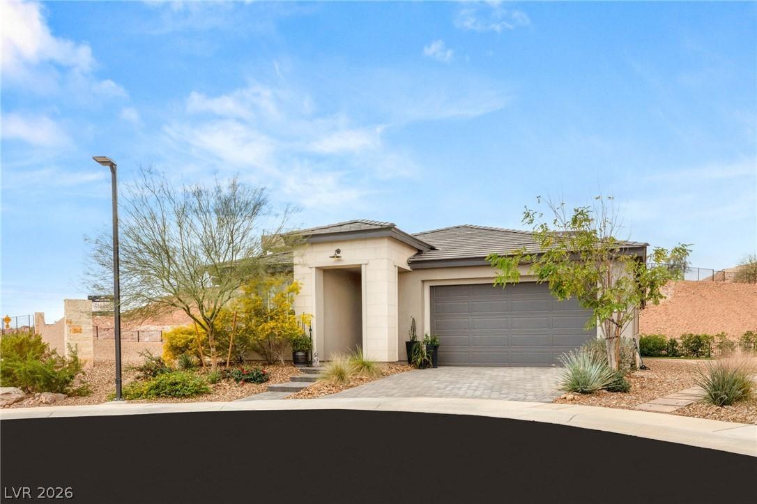 Image 2: This desert modern home features a welcoming entra