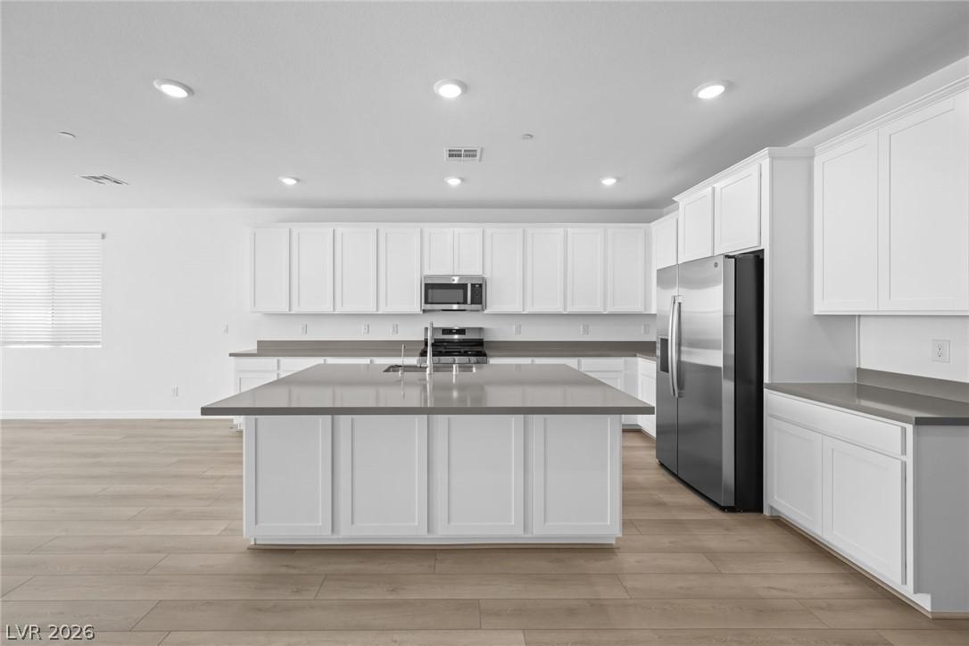 Image 3: A contemporary chef's kitchen boasts a spacious is