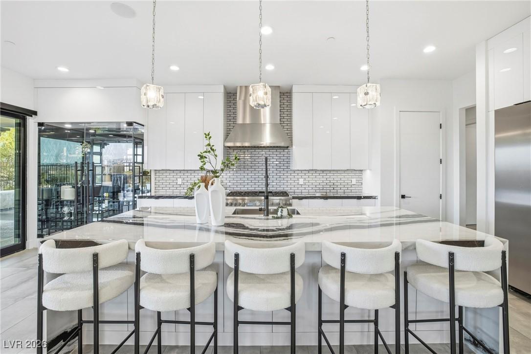 Image 2: Kitchen with white cabinets, pendant lighting, dar