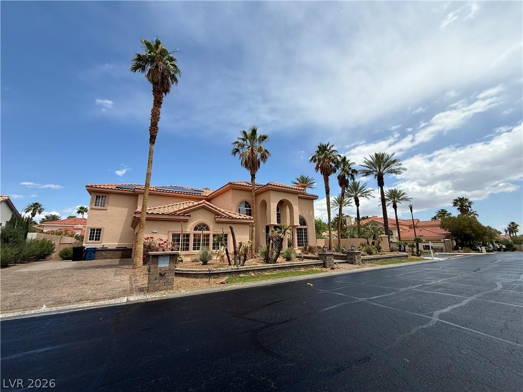 Image 2: A terracotta-roofed residence with desert landscap