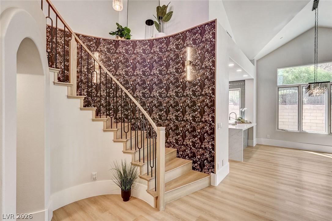 Image 4: A graceful staircase with intricate wrought iron r