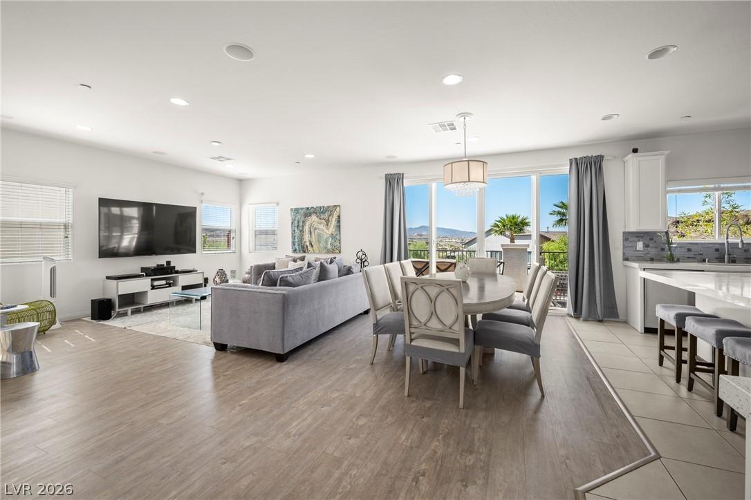 Image 3: Natural light illuminates an open-concept living s