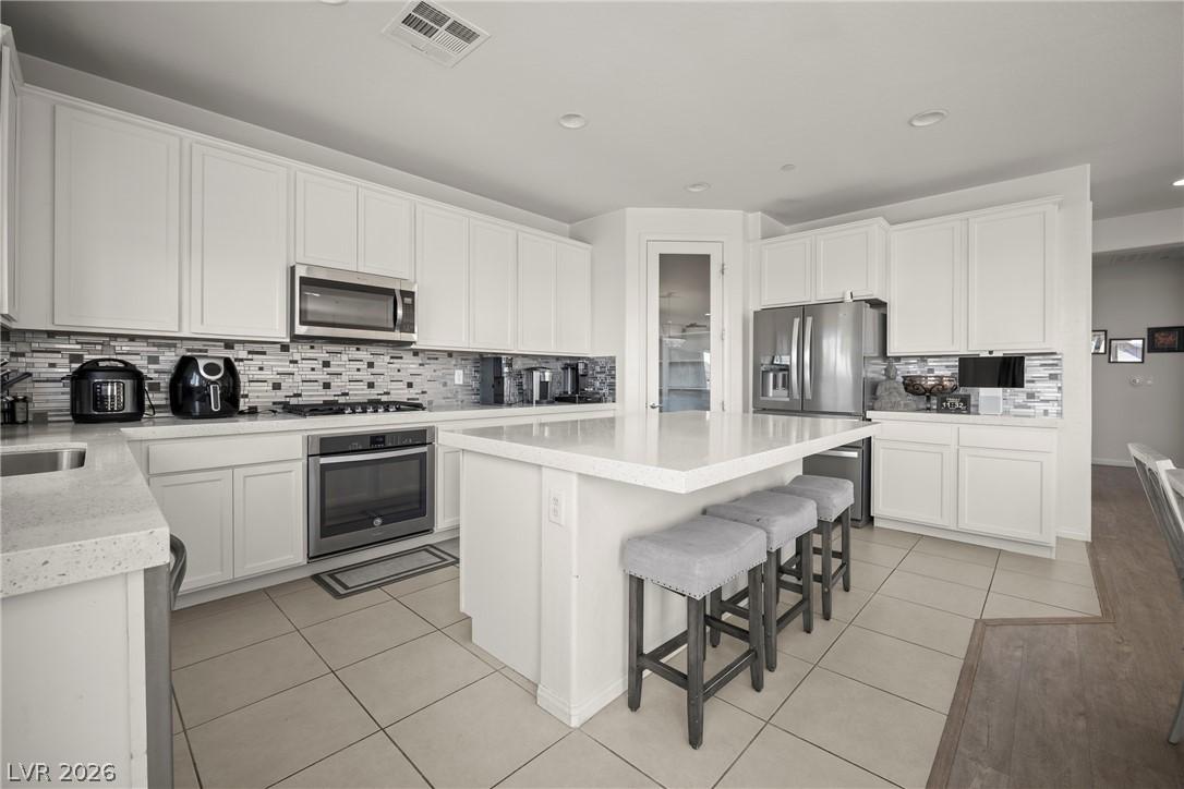 Image 4: A contemporary kitchen features bright white cabin