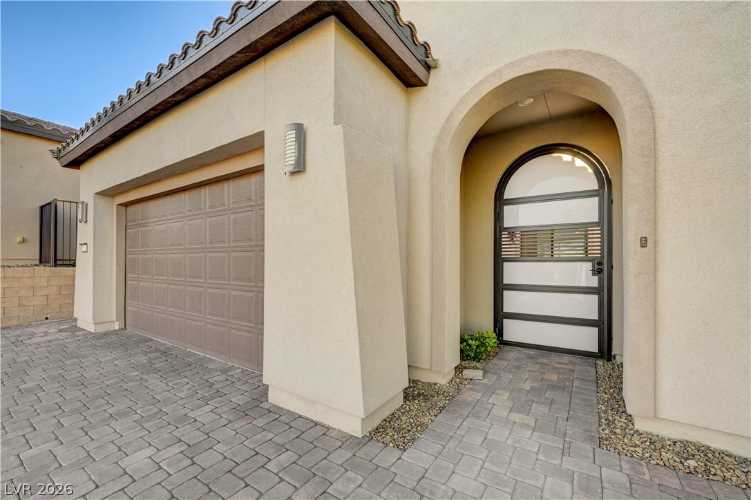 Image 4: Entrance to property featuring stucco siding, deco