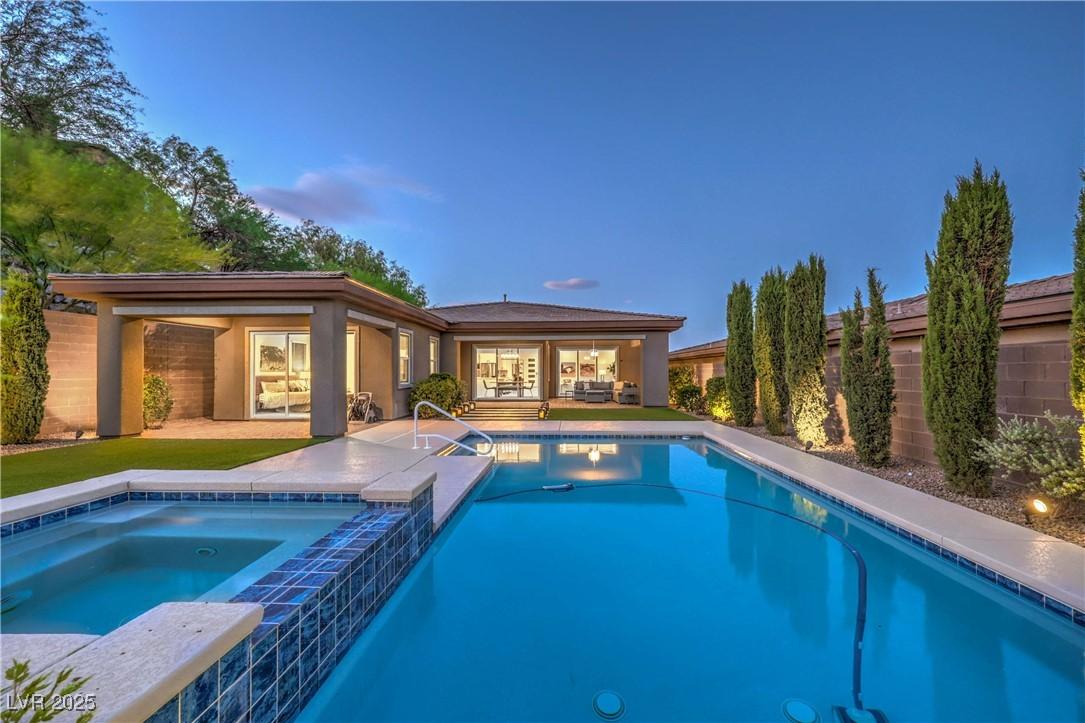 Image 2: View of pool with a patio area and a pool with con