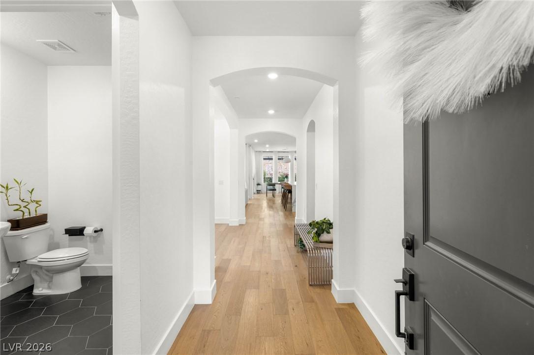 Image 4: This inviting entryway features warm wood flooring