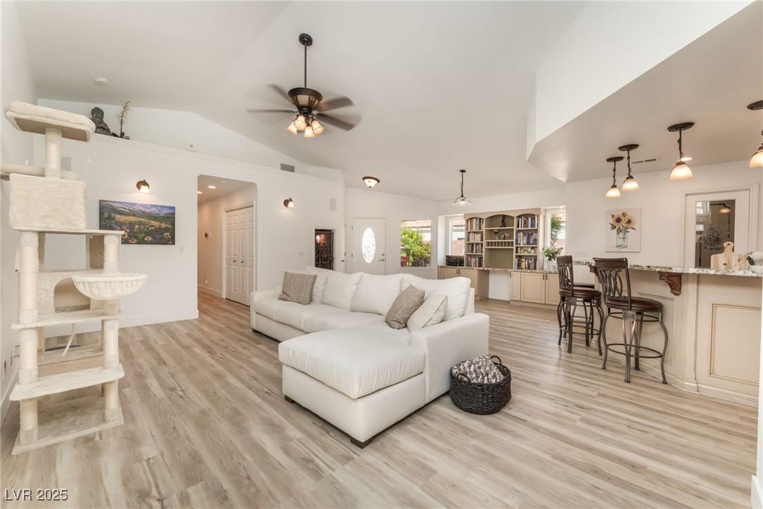 Image 3: Living room with vaulted ceiling, light wood finis