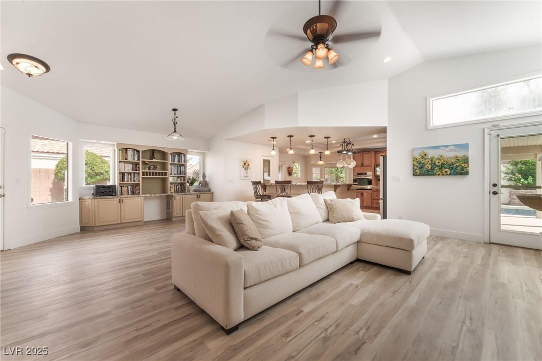 Image 4: Living room featuring vaulted ceiling, a ceiling f