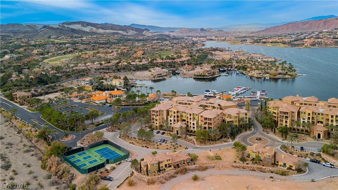 Image 1: A vibrant lakeside community with a marina, tennis