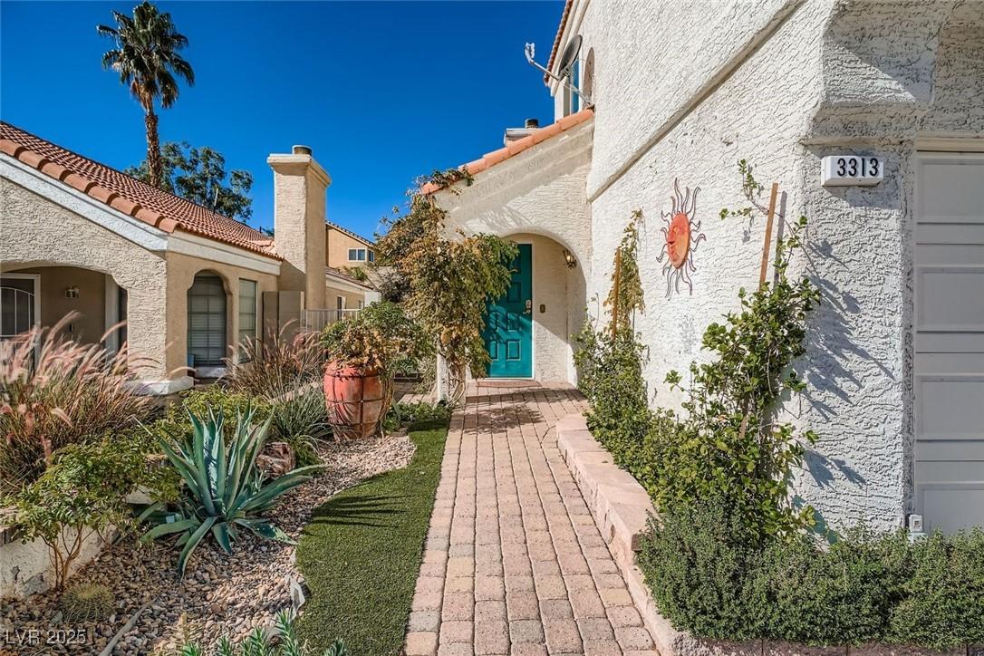 Image 2: Doorway to property featuring stucco siding and a
