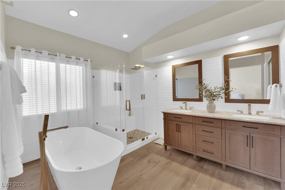 Image 3: Bathroom featuring lofted ceiling, double vanity,