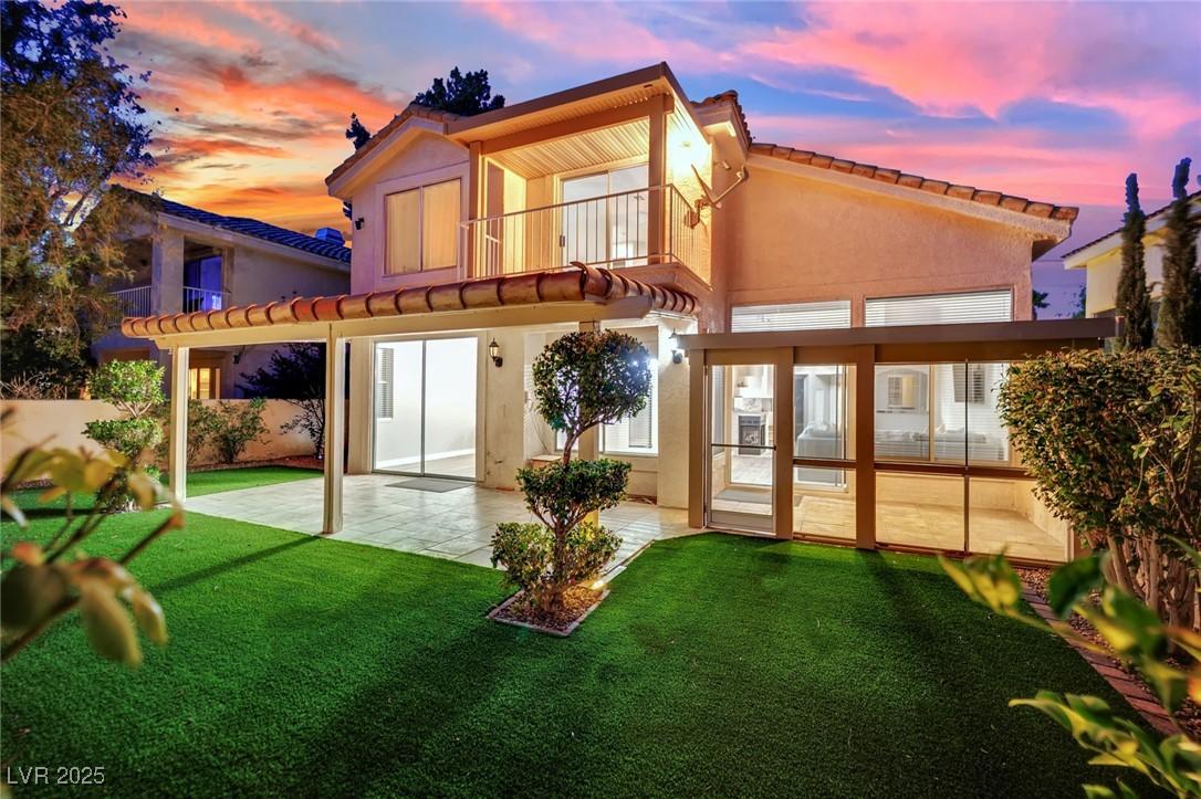 Image 4: Back of house at dusk featuring a patio area, a ba