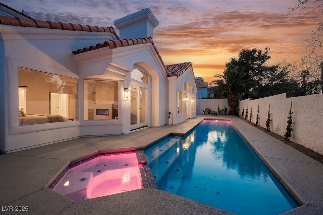Image 2: View of pool with a patio, a fenced backyard, and