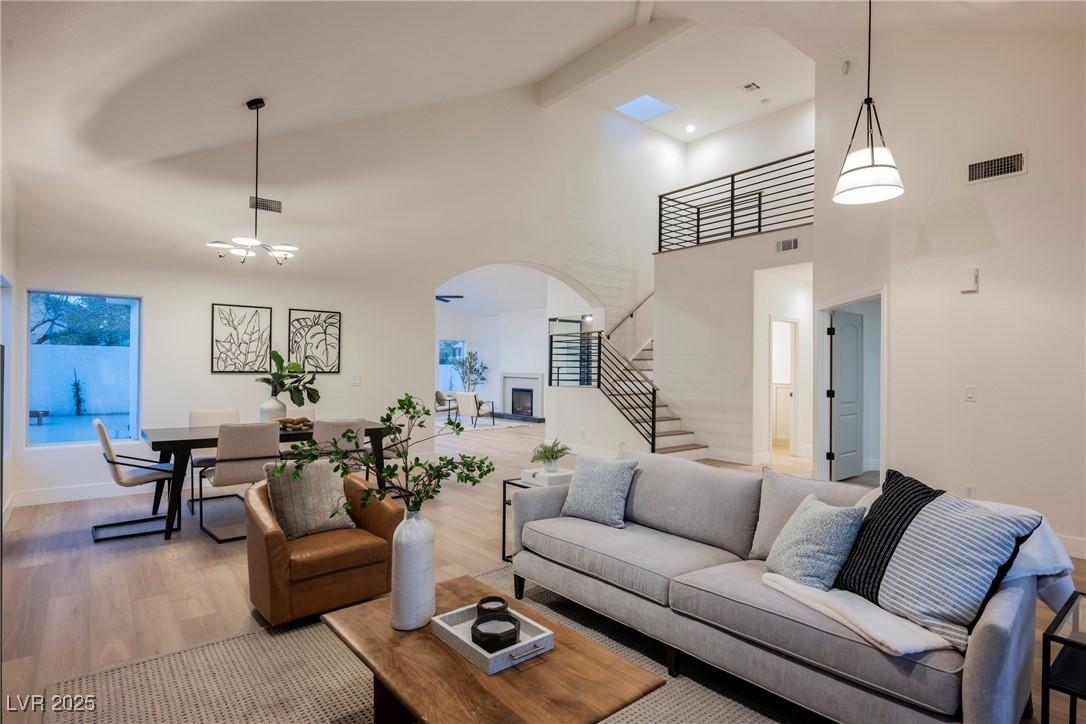 Image 3: Living room with arched walkways, stairway, light