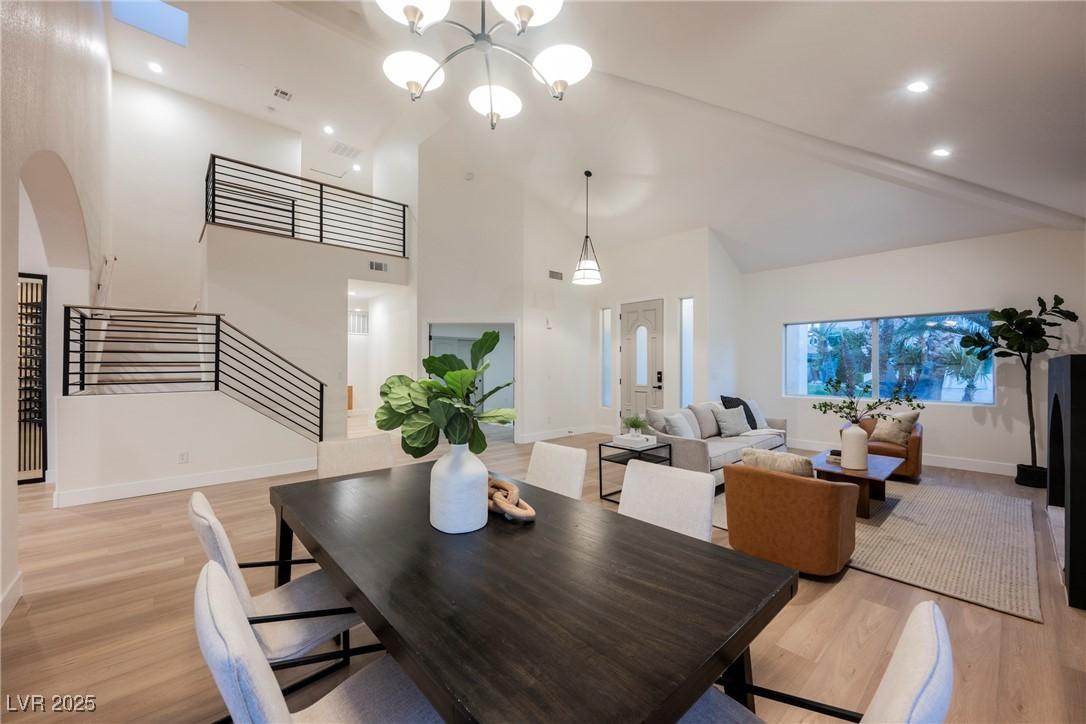 Image 4: Dining room featuring stairs, a chandelier, light