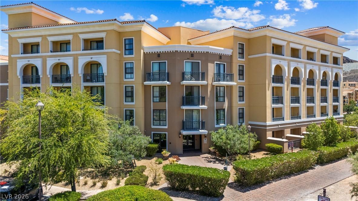 Image 1: This multi-story building features balconies and a