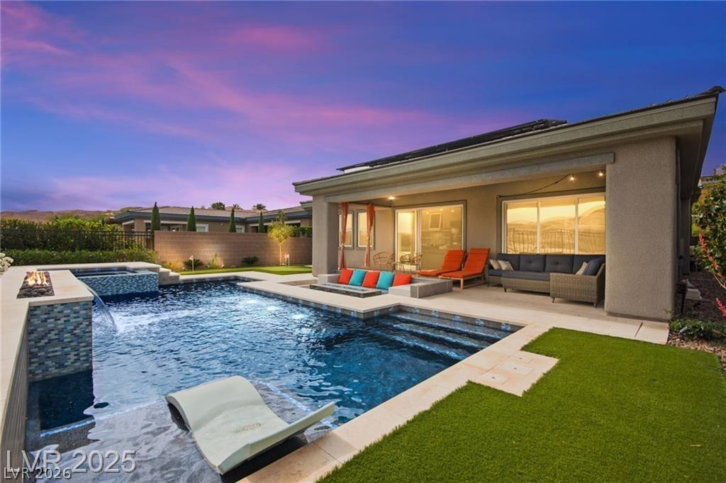Image 4: View of pool featuring a patio area, a fenced back