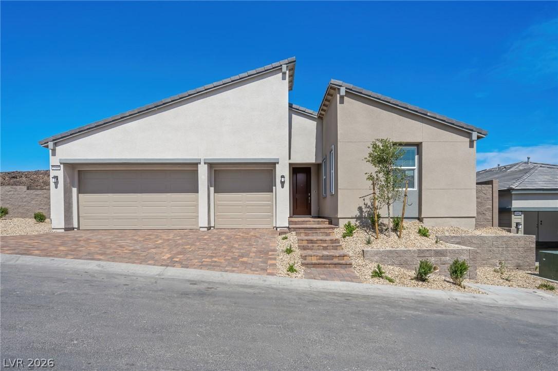 Image 1: A modern facade with a two-car garage and a steppe