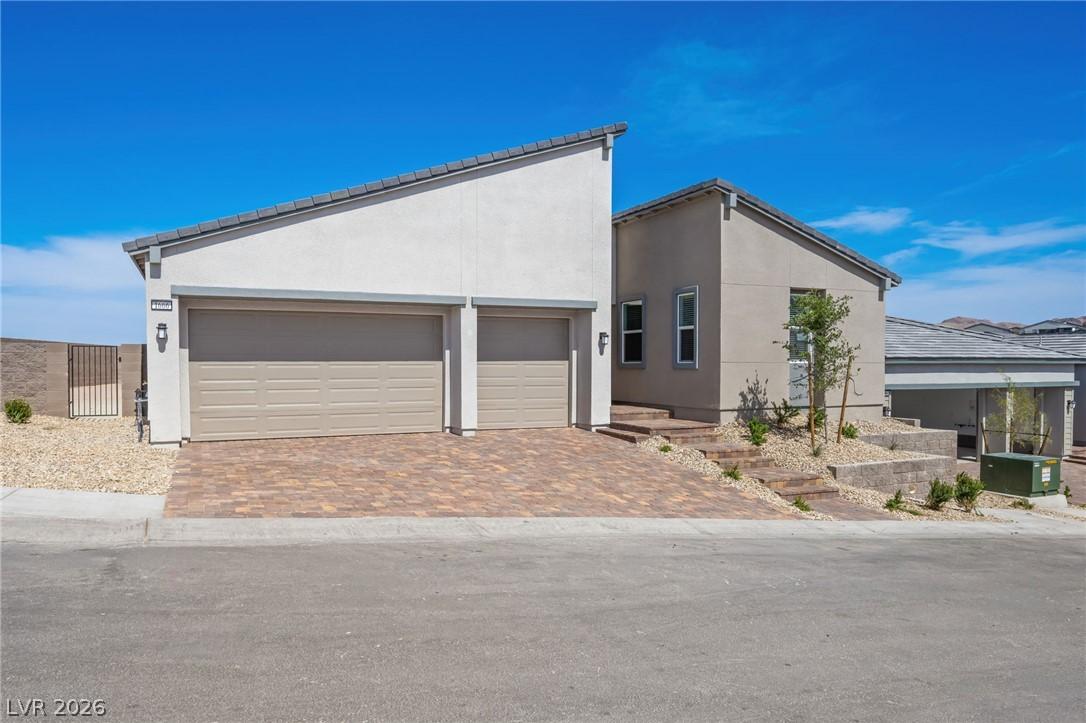 Image 2: Modern desert home featuring a two-car garage with